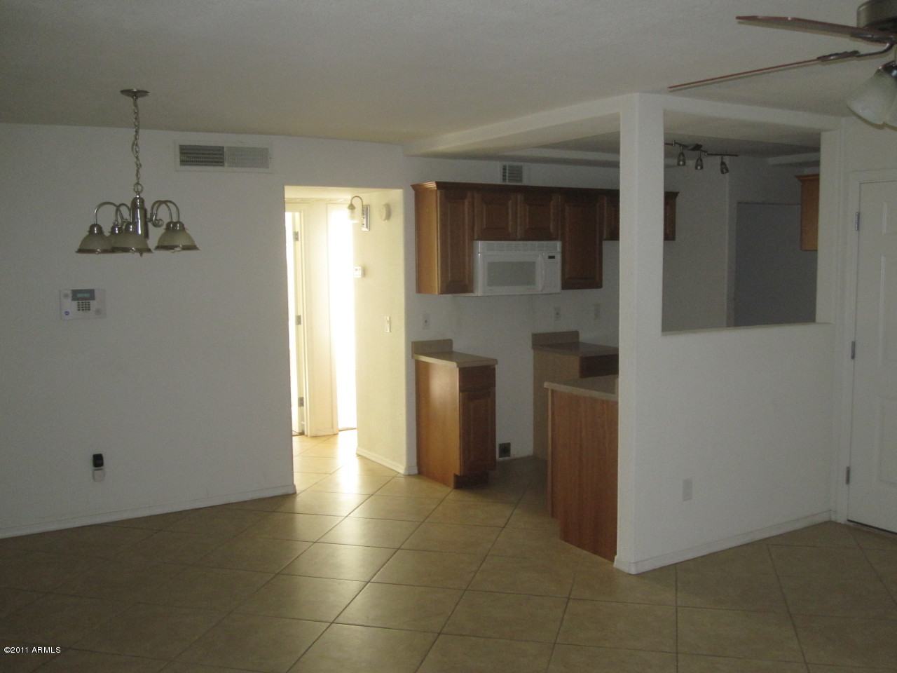 2121 West Royal Palm Road, Unit 1016 Phoenix, AZ 85021 - Photo 5 of 10 a view of a kitchen with a refrigerator a stove top oven and cabinets