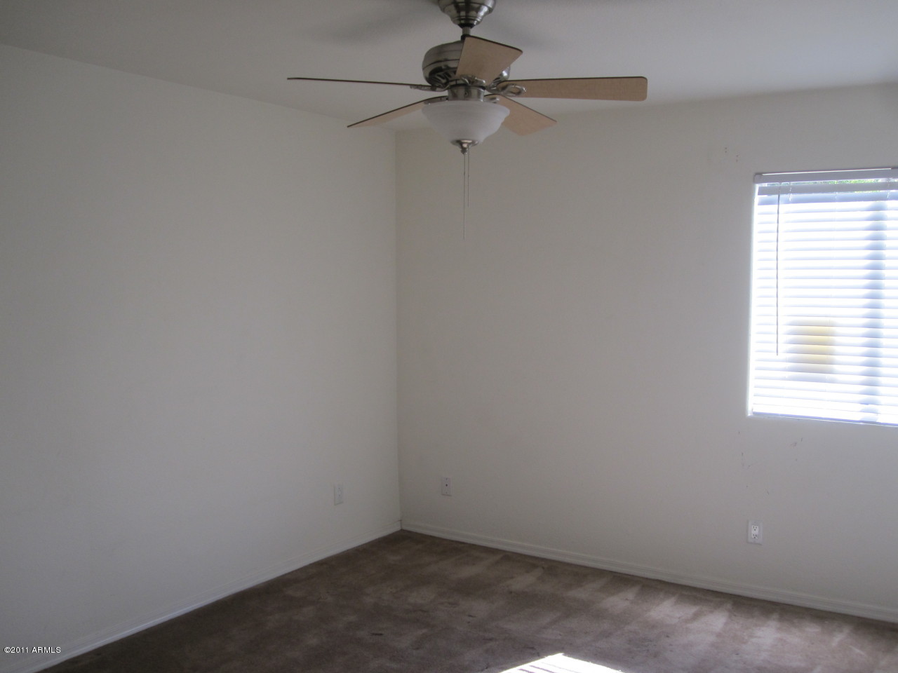 2121 West Royal Palm Road, Unit 1016 Phoenix, AZ 85021 - Photo 9 of 10 a view of a small space with a window and a fan