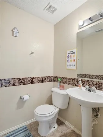 a bathroom with a sink mirror vanity and toilet