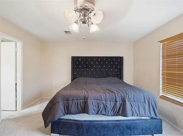 a bedroom with a bed and window