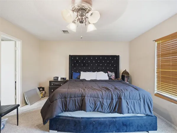 a bedroom with a bed and window