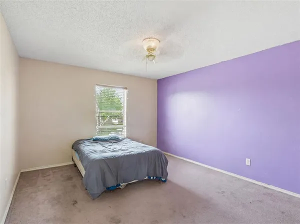 a bedroom with a bed and window