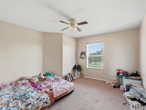 a bedroom with bed and a window