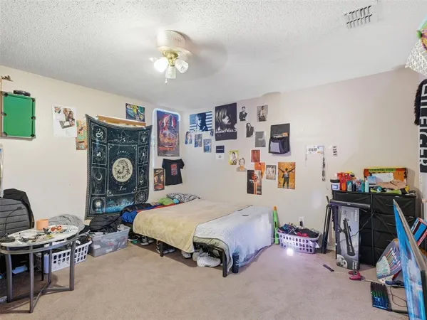 a bedroom with bed and a chandelier