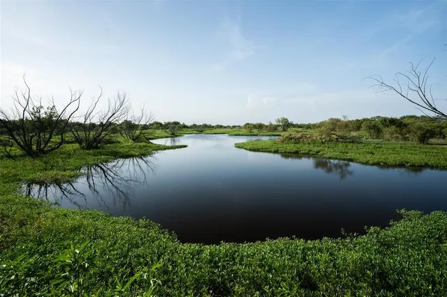 an aerial view of lake and residential houses with outdoor space
