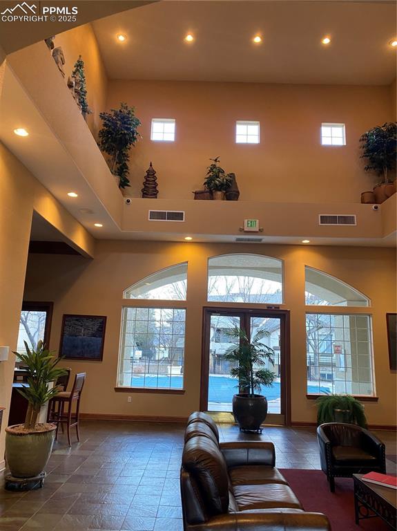 3715 Riviera Grove, Unit 201 Colorado Springs, CO 80922 - Photo 20 of 32 a living room with furniture a large window and a chandelier