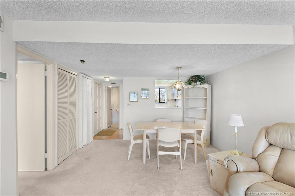 5413 Southeast Miles Grant Road, Unit G206 Stuart, FL 34997 - Photo 7 of 79 a dining room with furniture and window