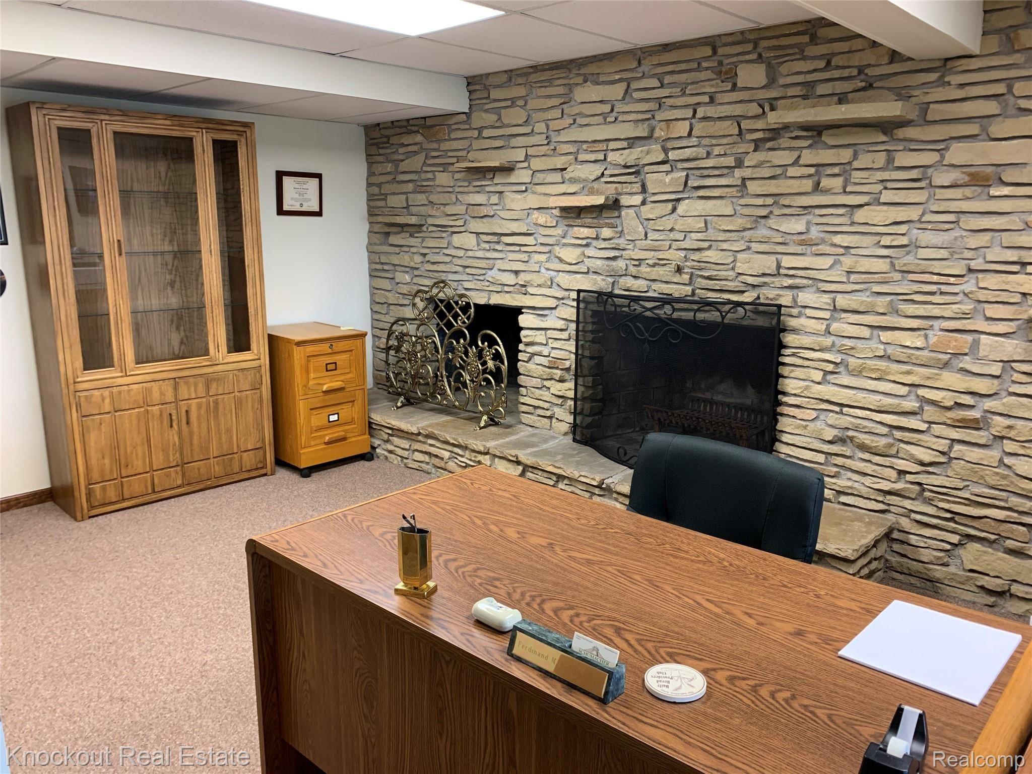 9252 Ormes Road Vassar, MI 48768 - Photo 36 of 64 Basement fireplace with unique stone wall, used as office for owner's business