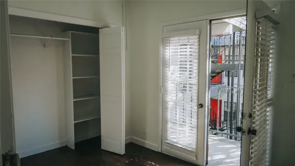 a view of walk in closet with clothes