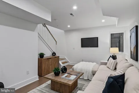 a bedroom with a bed and a potted plant
