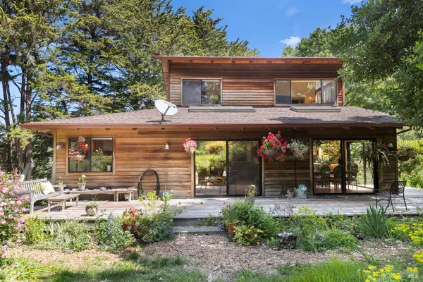 a backyard of a house with yard and outdoor seating