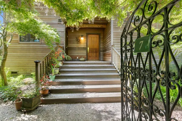 a view of a house with potted plants