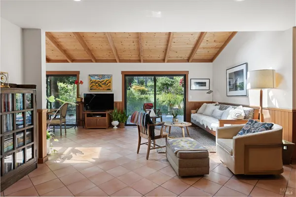 a dining room with furniture a chandelier and wooden floor