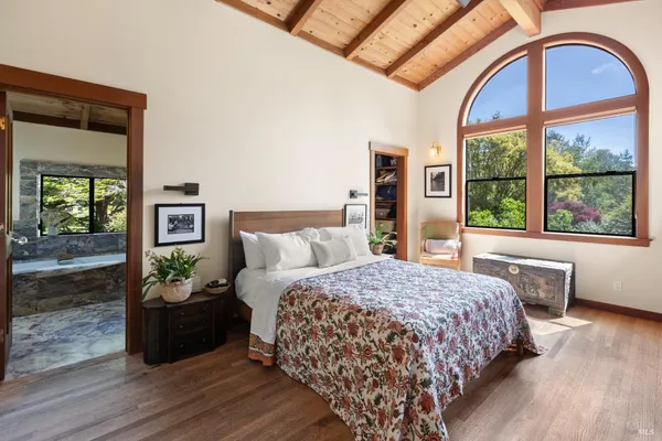 a bedroom with a bed a couch and dresser