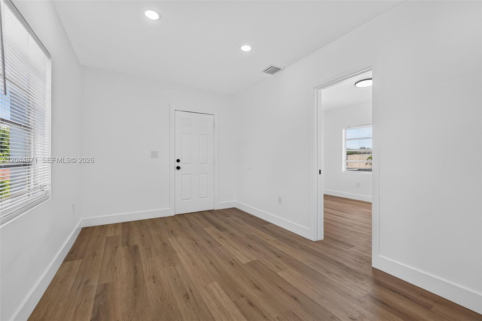 1900 Southwest 6th Street, Unit 6 Miami, FL 33135 - Photo 7 of 20 an empty room with wooden floor and windows