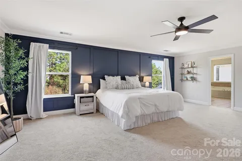 a spacious bedroom with a bed and a table