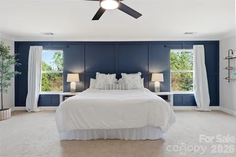 a bedroom with a large bed and a large window