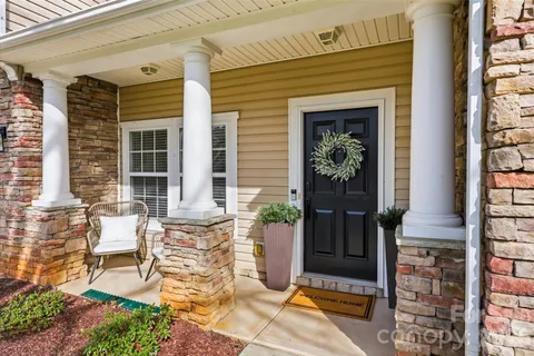 a view of a patio with table and chairs and potted plants