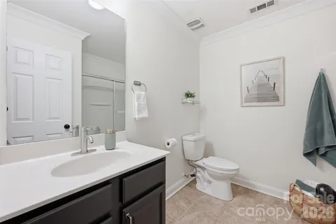 a bathroom with a sink toilet and a mirror