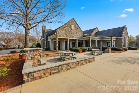 a swimming pool with outdoor seating and yard