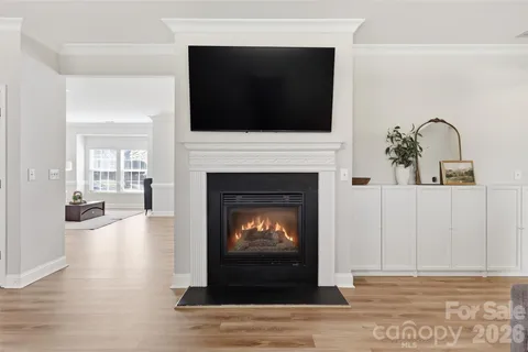 a living room with a fireplace and a flat screen tv