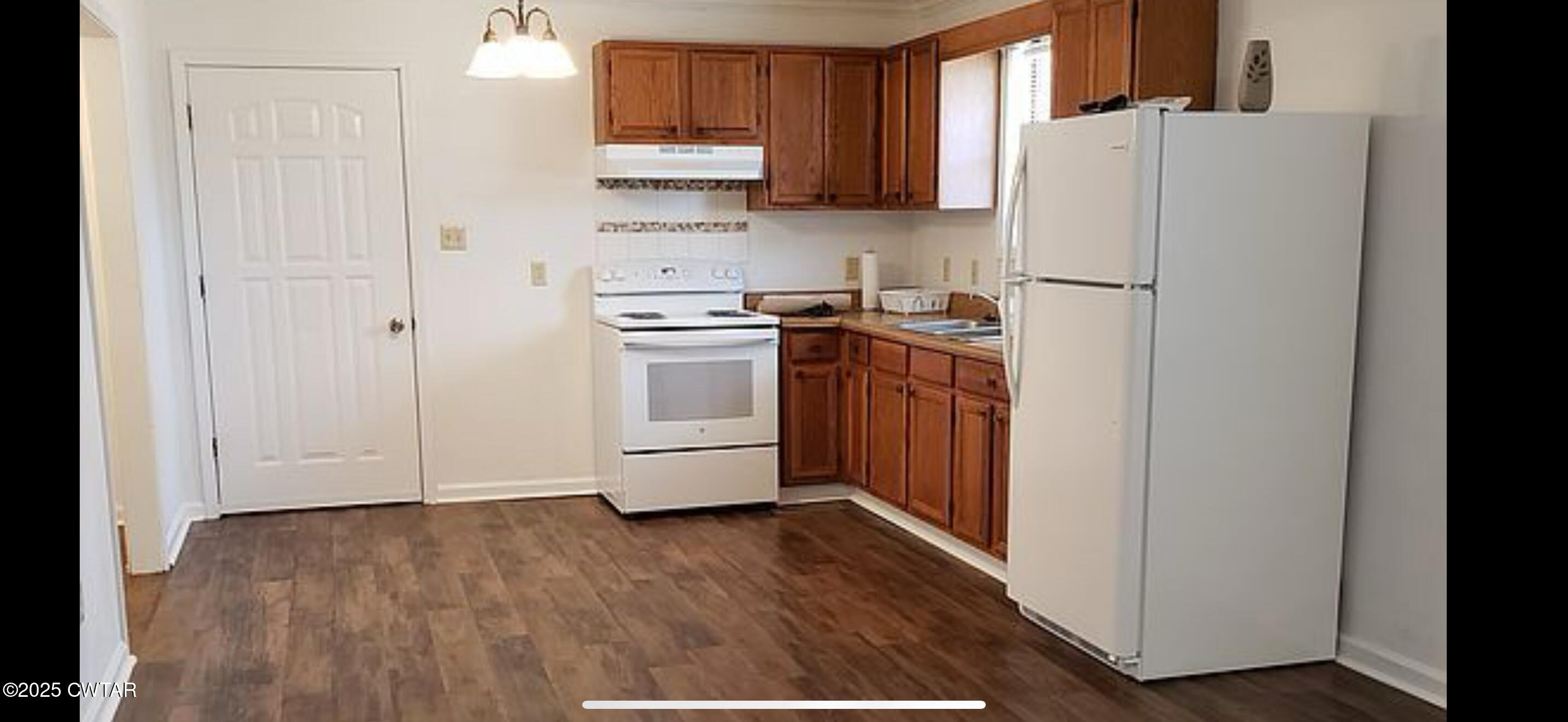 65 Magnolia Road Tiptonville, TN 38079 - Photo 3 of 11 a kitchen with stainless steel appliances a refrigerator and a stove