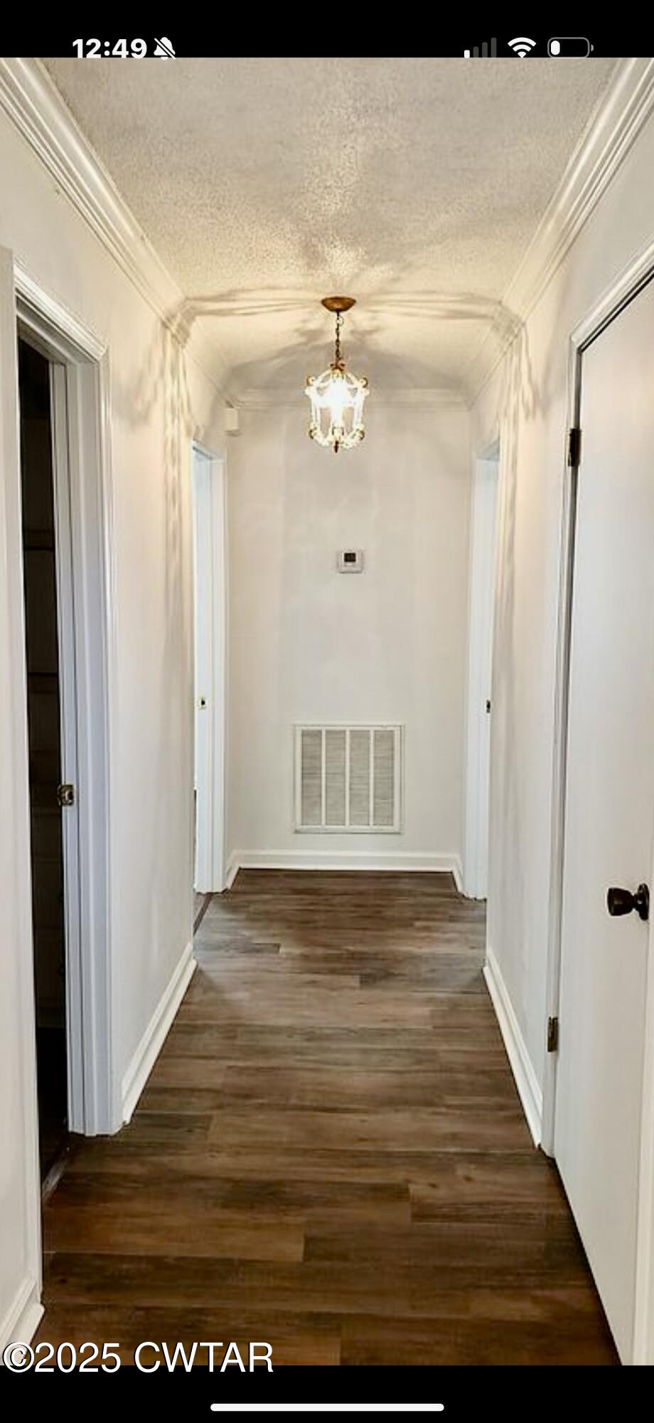 65 Magnolia Road Tiptonville, TN 38079 - Photo 5 of 11 a view of an empty room with wooden floor and a ceiling fan