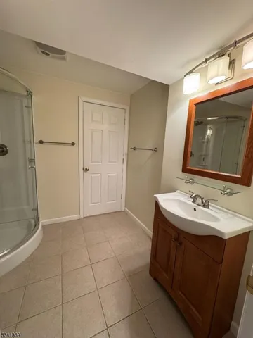 a bathroom with a sink a toilet and large mirror