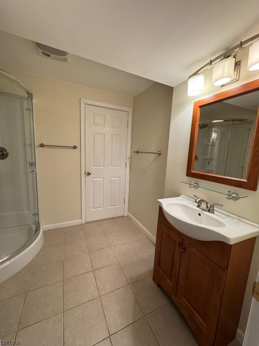 10 Hopkinson Court Bernards, NJ 07920 - Photo 14 of 17 a bathroom with a sink a toilet and large mirror