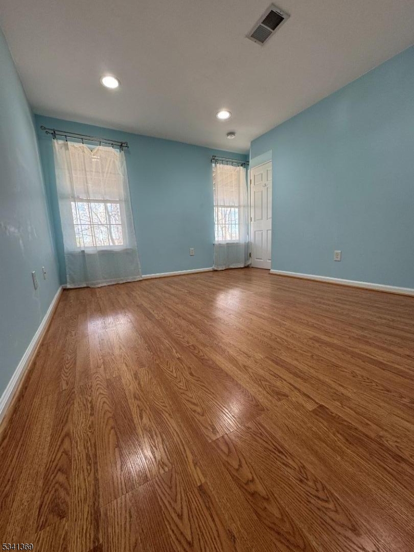 10 Hopkinson Court Bernards, NJ 07920 - Photo 16 of 17 an empty room with wooden floor and windows