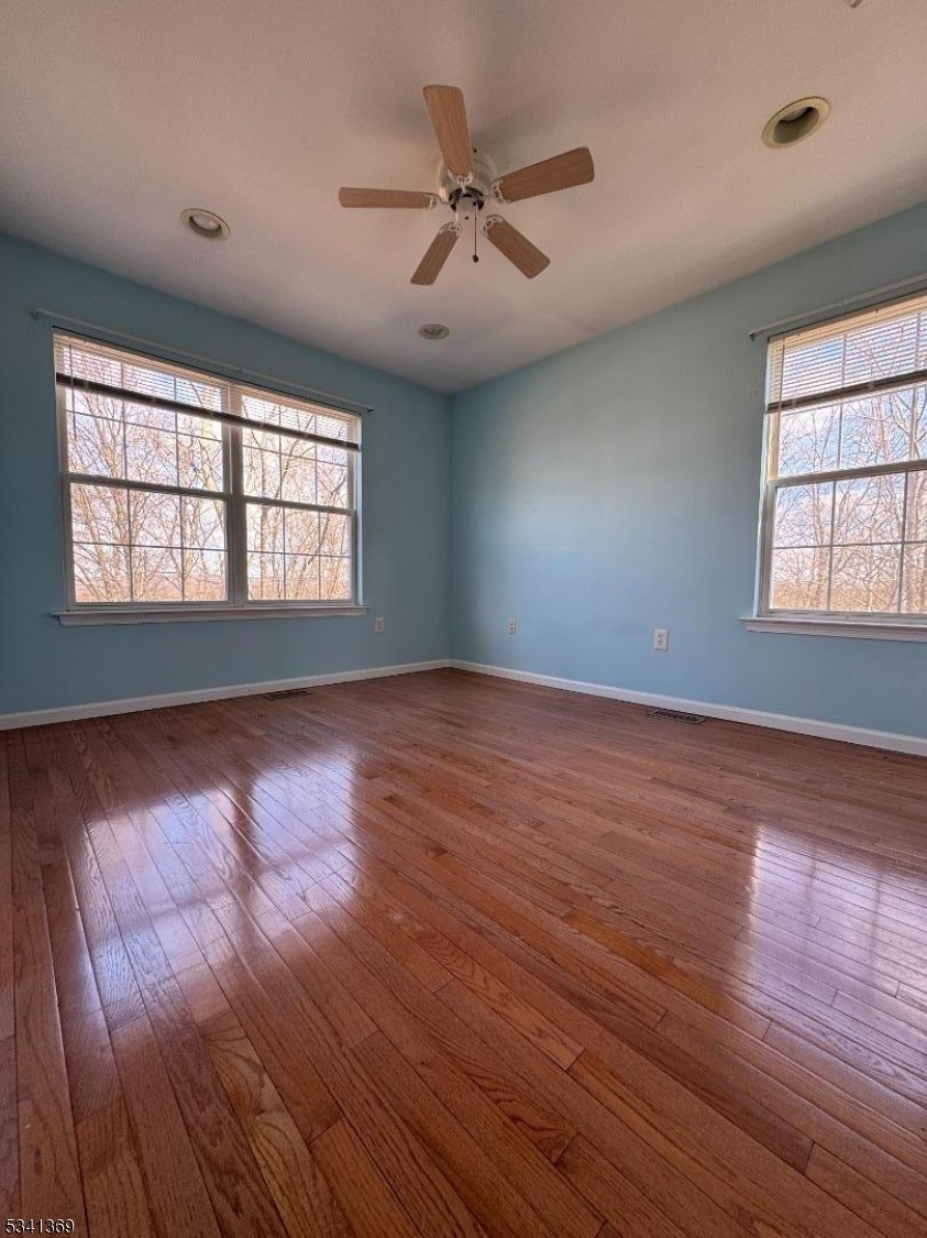 10 Hopkinson Court Bernards, NJ 07920 - Photo 7 of 17 a view of an empty room with wooden floor and a window