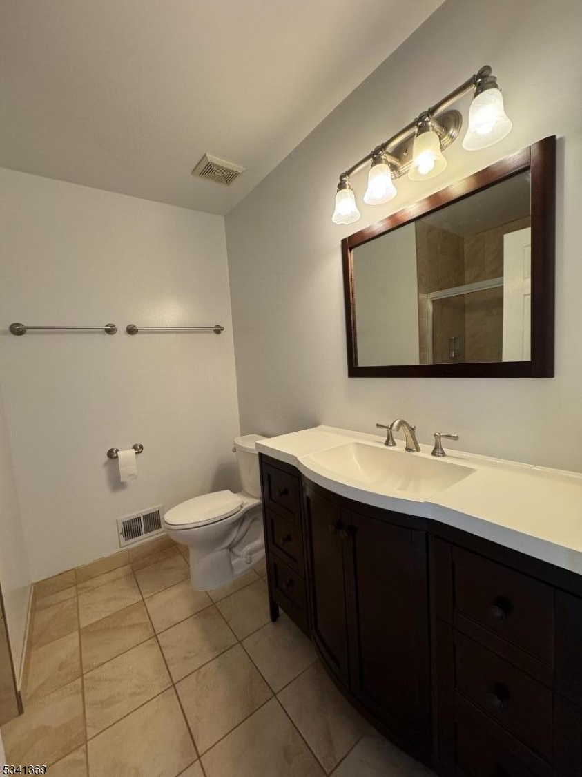 10 Hopkinson Court Bernards, NJ 07920 - Photo 8 of 17 a bathroom with a toilet sink and mirror