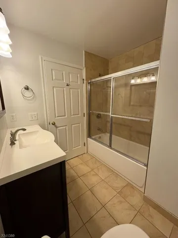 a bathroom with a sink mirror and shower