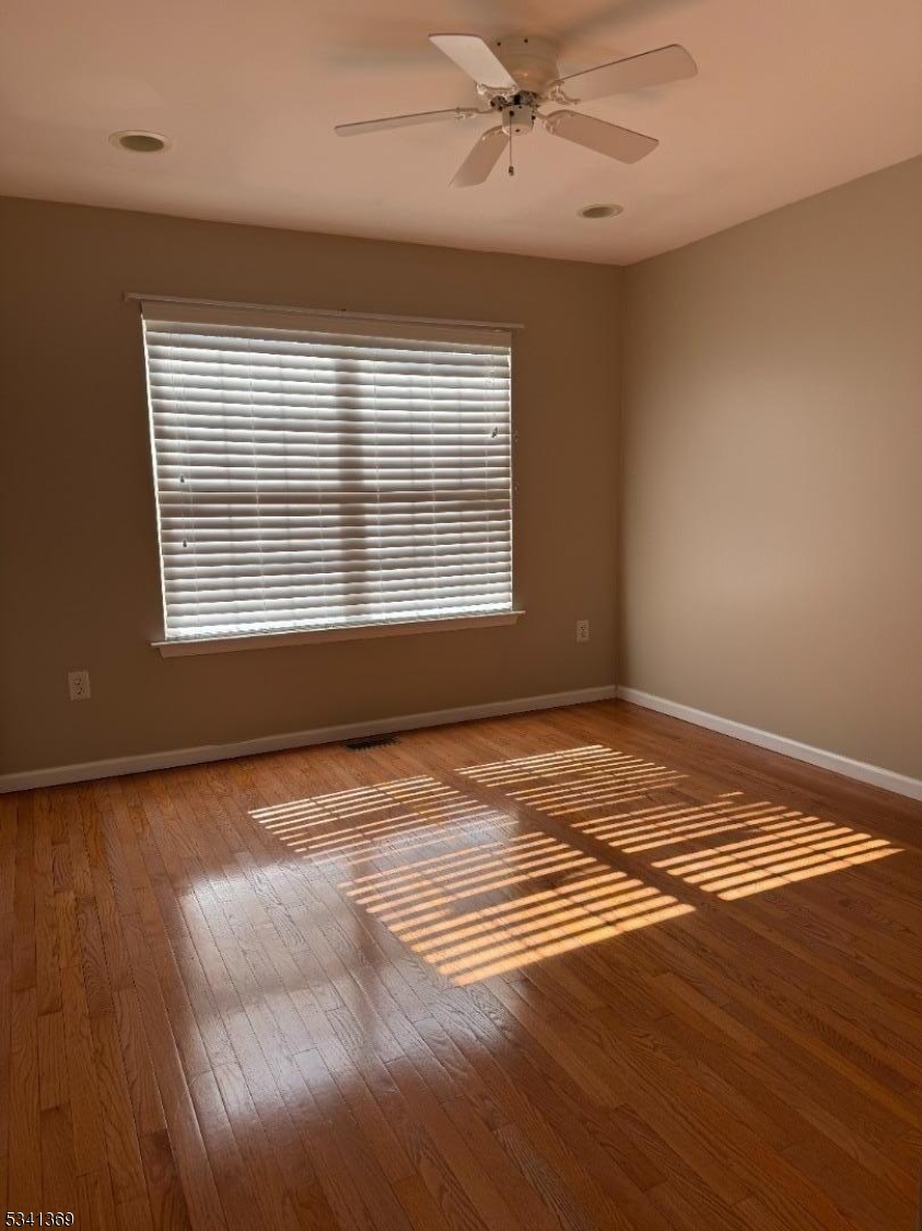 10 Hopkinson Court Bernards, NJ 07920 - Photo 10 of 17 a view of an empty room with a window and wooden floor