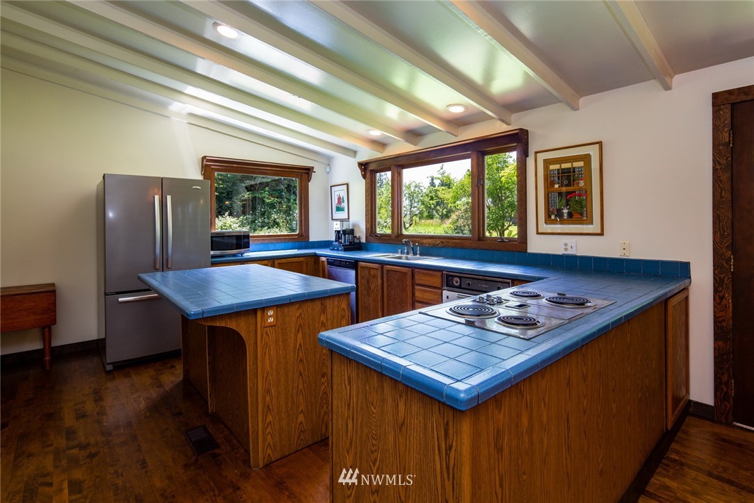 5413 Barr Road Ferndale, WA 98248 - Photo 13 of 40 a wooden table sitting in a kitchen next to a window