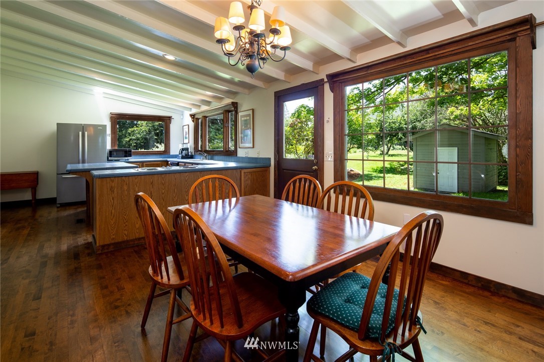 5413 Barr Road Ferndale, WA 98248 - Photo 17 of 40 a dining room with furniture a chandelier and wooden floor