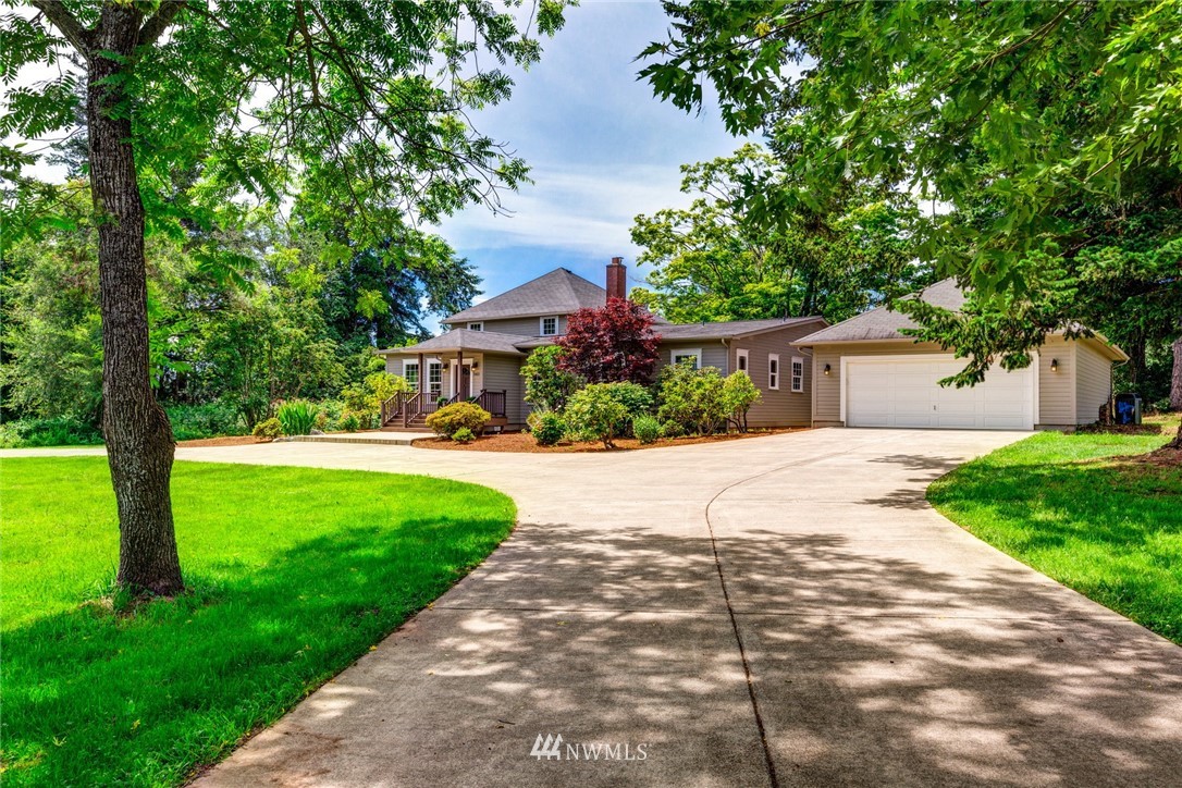5413 Barr Road Ferndale, WA 98248 - Photo 32 of 40 a view of a white house with a big yard plants and large trees