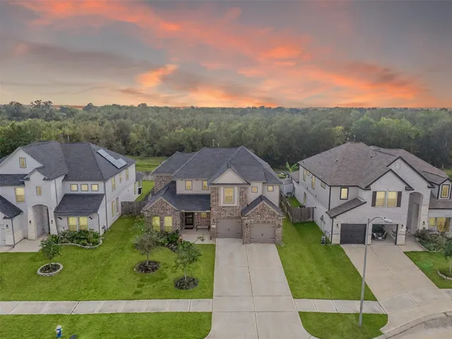 an aerial view of multiple houses with a yard
