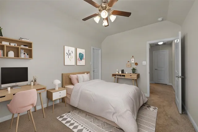 a bedroom with a bed and a desk with chair