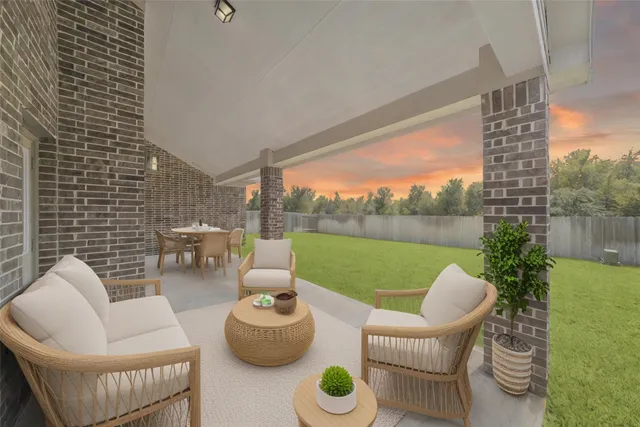 a view of a patio with couches chairs and a potted plant