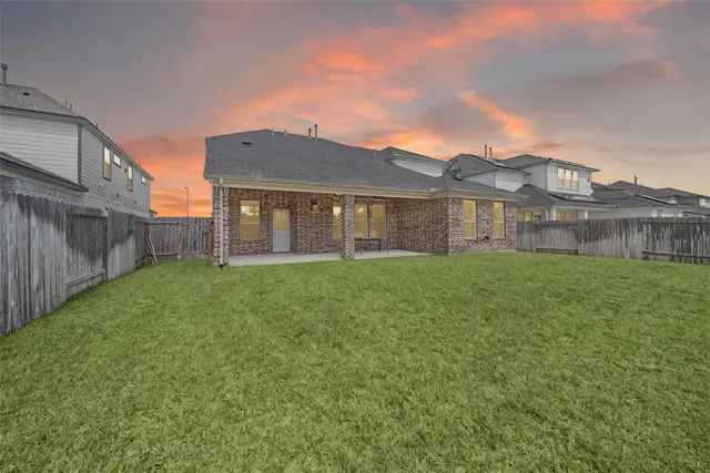 a front view of house with a garden