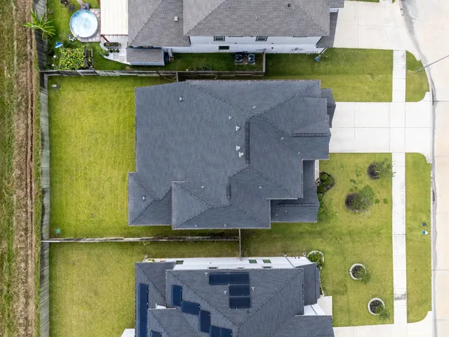 an aerial view of a house with a swimming pool