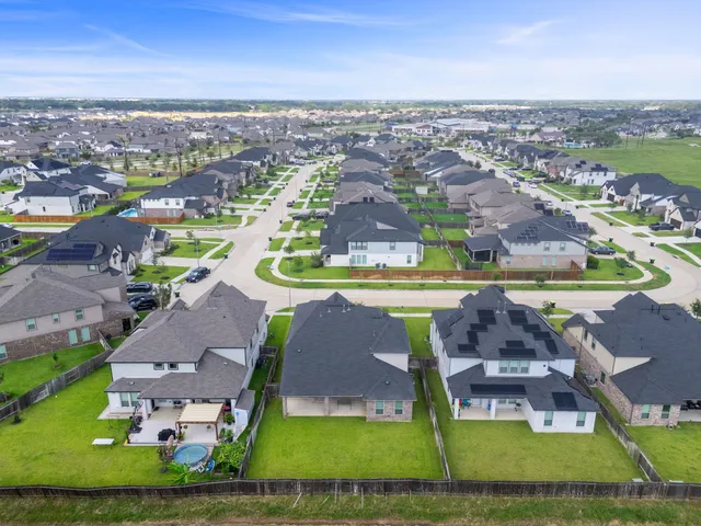 an aerial view of residential houses with outdoor space