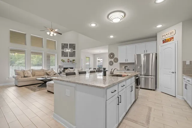 a large white kitchen with a large window