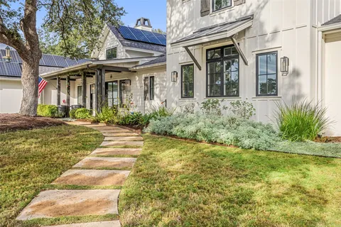 a front view of a house with garden