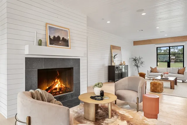 a living room with furniture and a fireplace