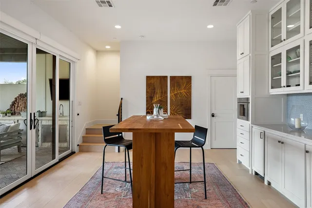 a kitchen with stainless steel appliances kitchen island a chandelier