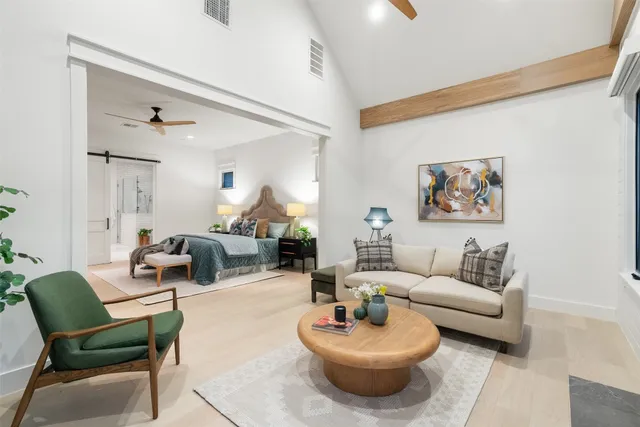 a living room with furniture and a wooden floor