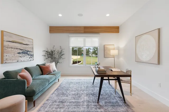 a living room with furniture potted plant and a table