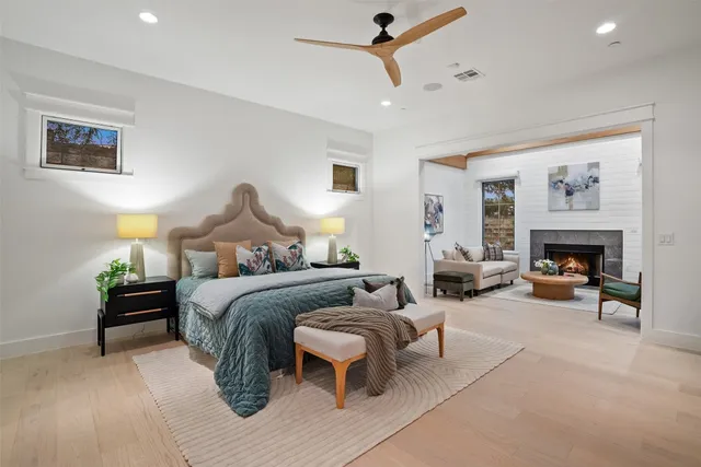 a bedroom with furniture and a fireplace